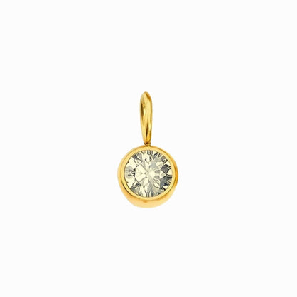 Gold pendant with a clear gemstone on a white background