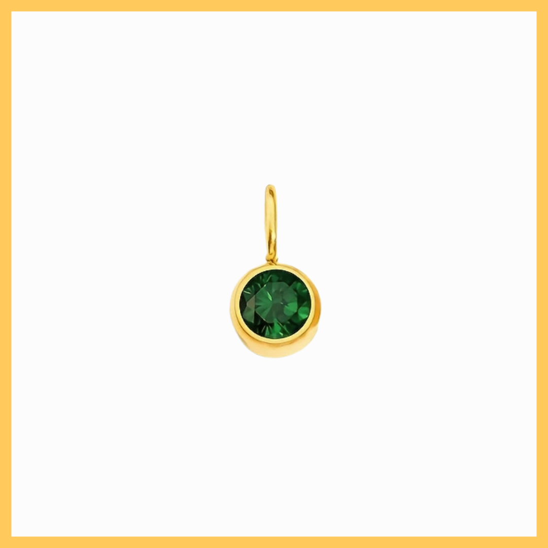 Gold pendant with a green gemstone on a white background