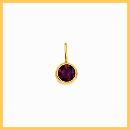 Gold earring with a purple gemstone on a white background