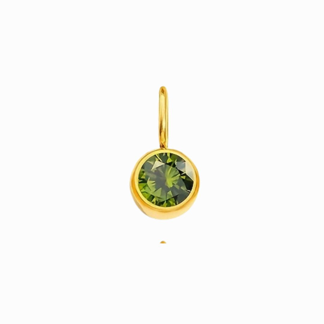 Gold pendant with a green gemstone on a white background