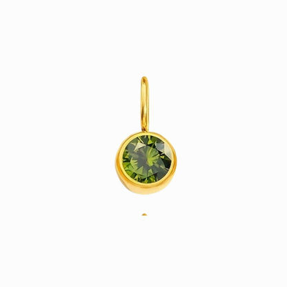 Gold pendant with a green gemstone on a white background