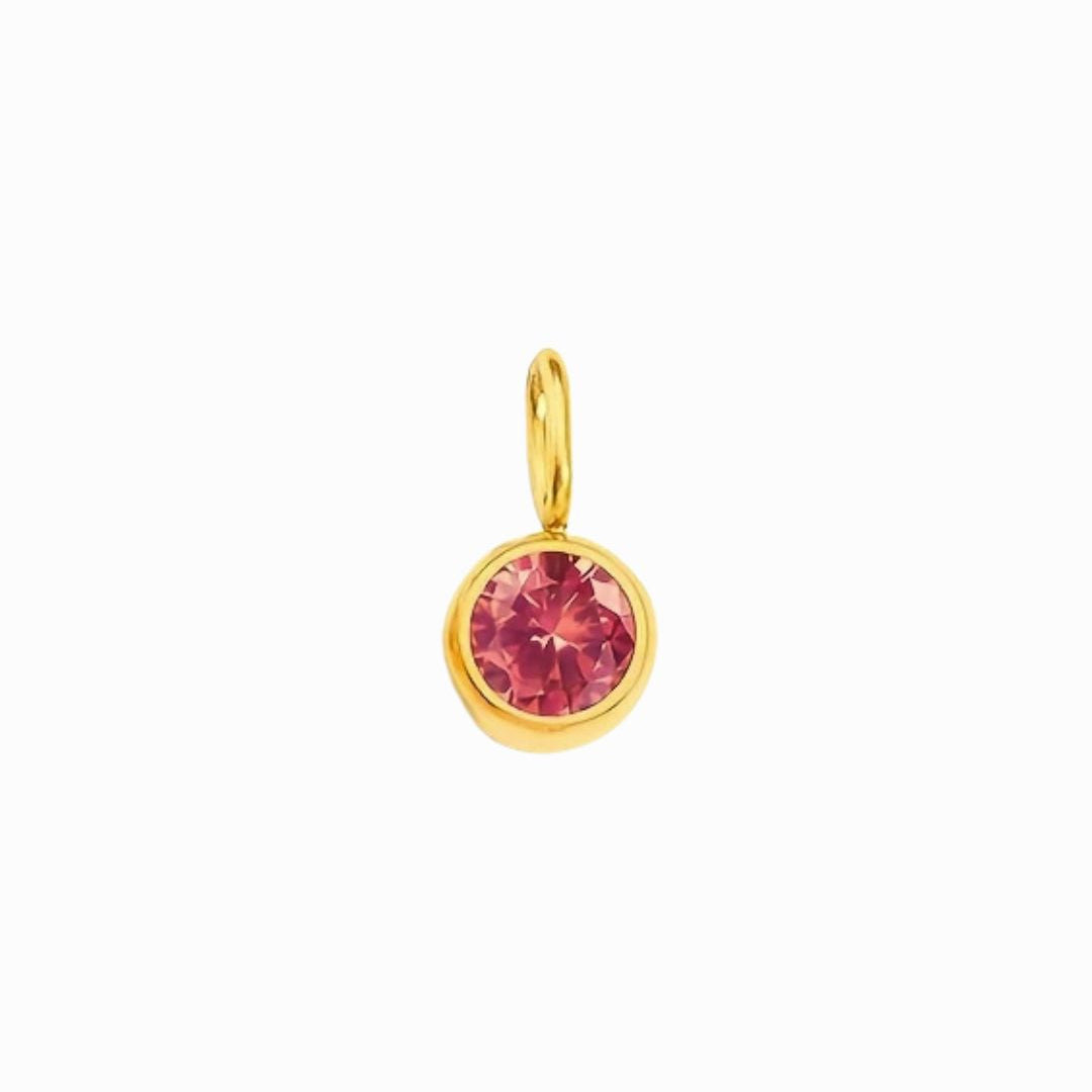 Gold pendant with a pink gemstone on a white background
