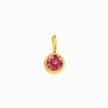 Gold pendant with a pink gemstone on a white background