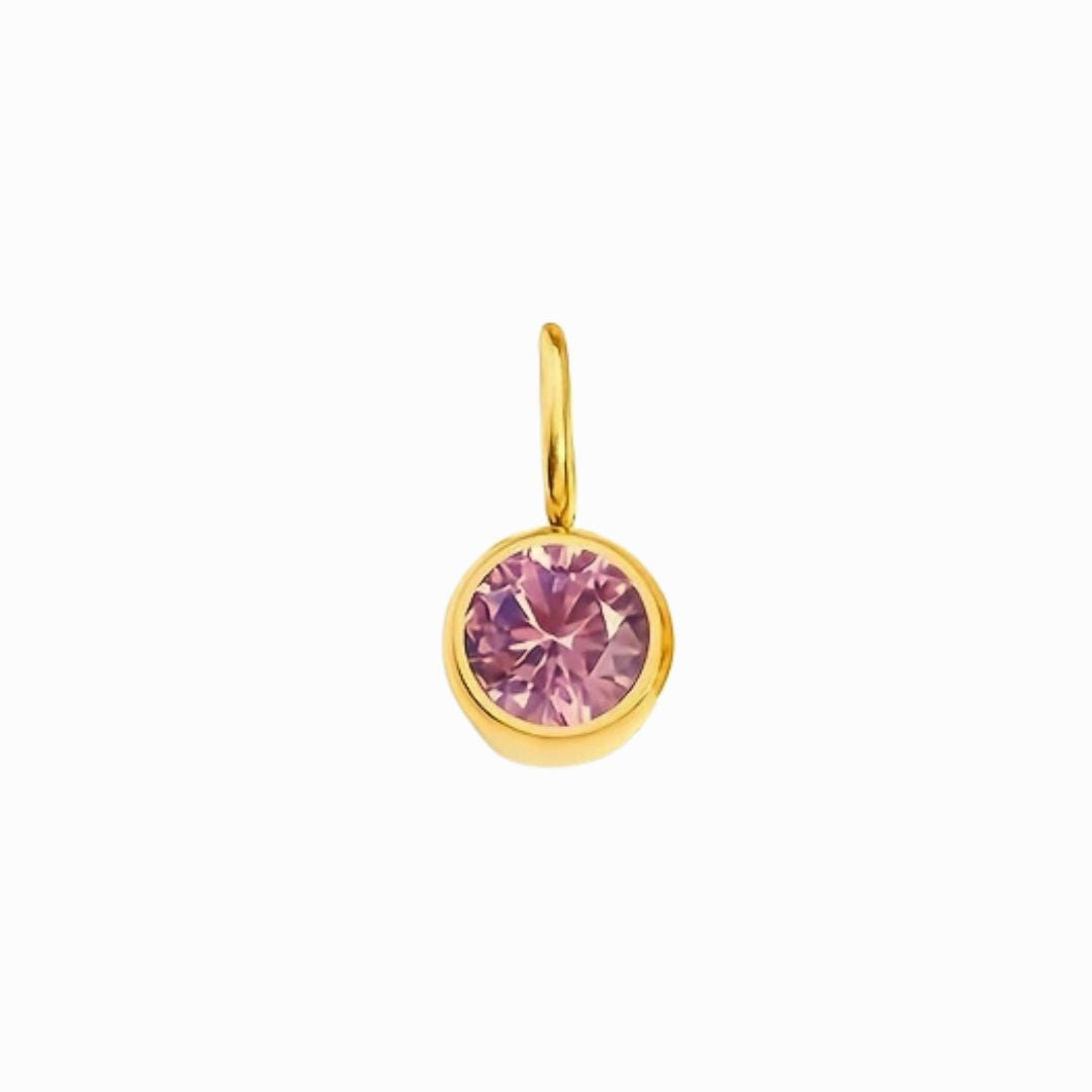 Gold pendant with a pink gemstone on a white background