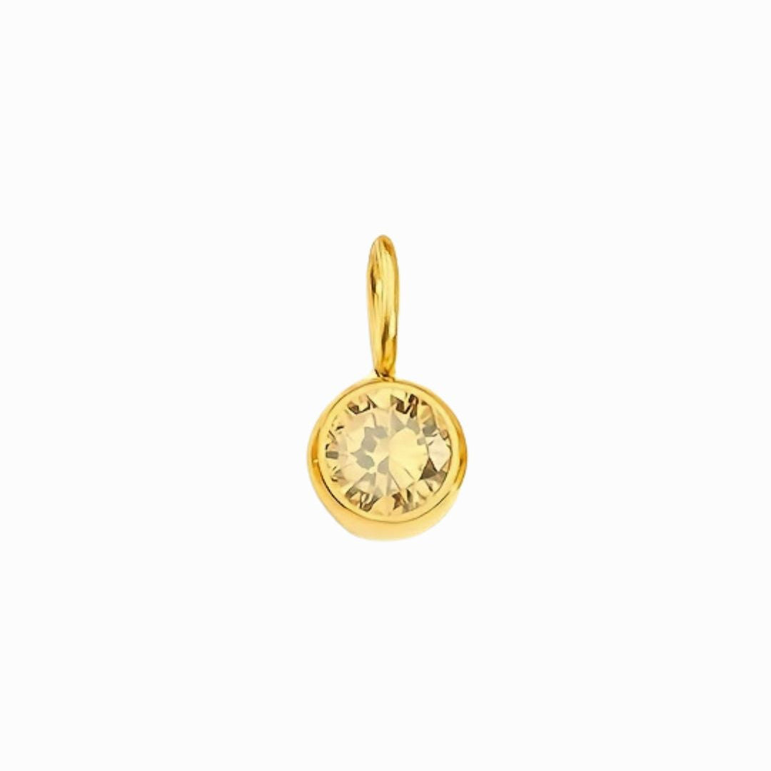 Gold pendant with a yellow gemstone on a white background
