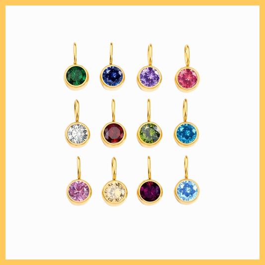 Set of gold earrings with colorful gemstones on a white background