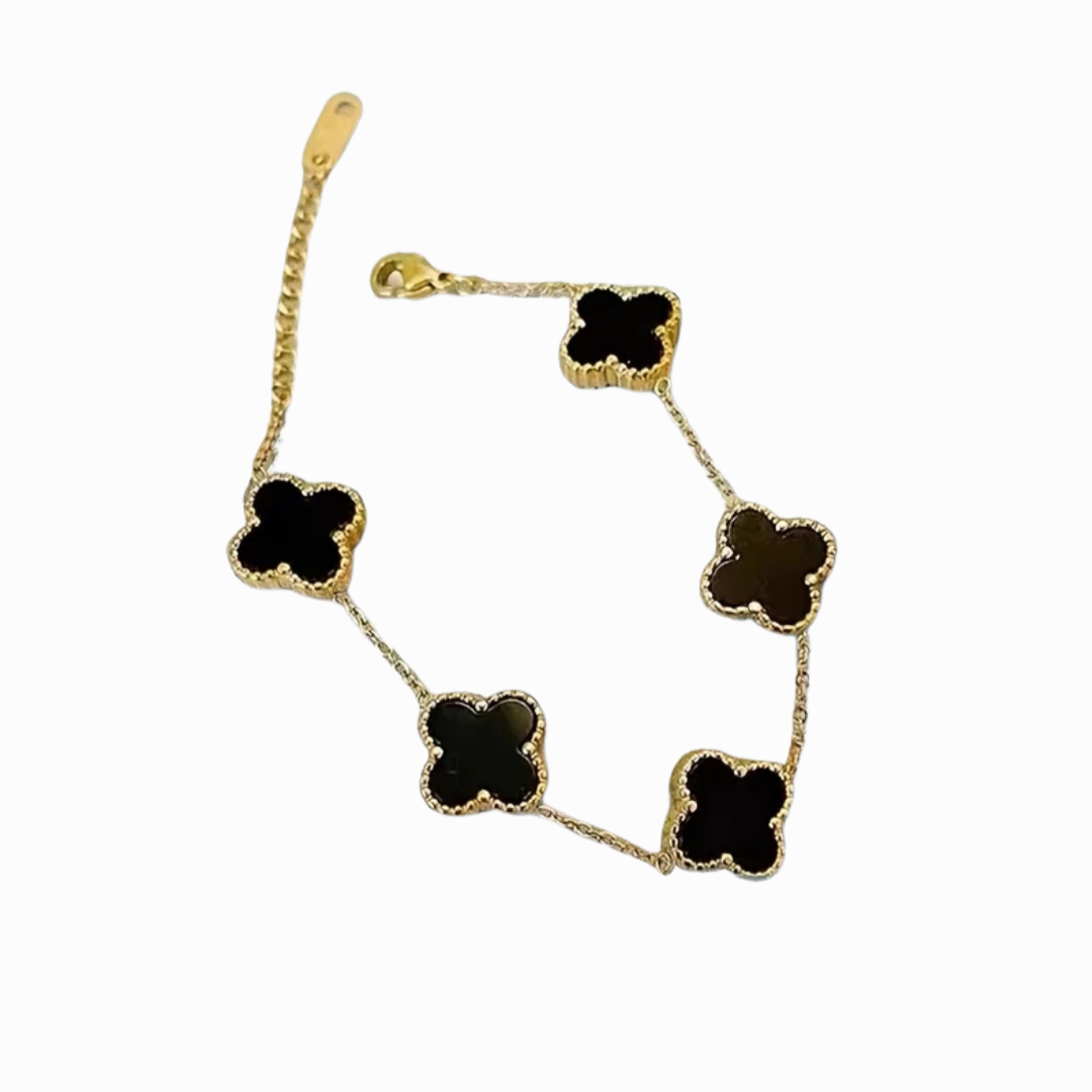 Gold necklace with black clover-shaped pendants on a white background