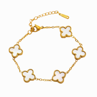 Gold bracelet with white clover-shaped charms on a white background