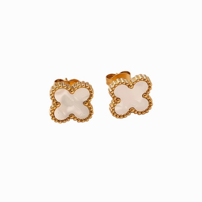 Pair of white four-leaf clover earrings with gold frames on a white background
