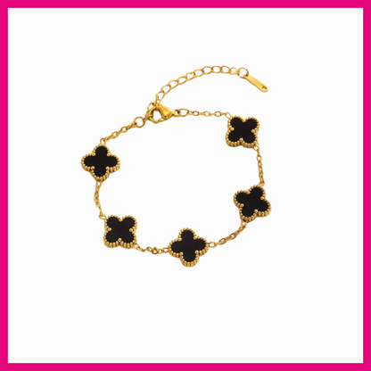 Gold bracelet with black clover-shaped charms on a white background