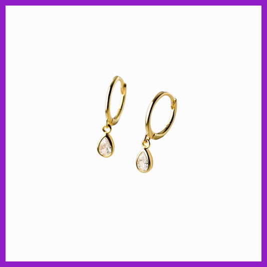 Gold earrings with clear stones on a white background