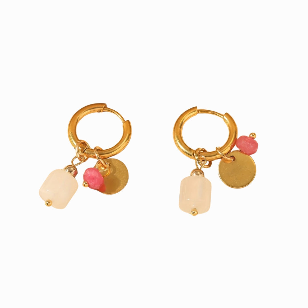 Gold hoop earrings with colorful charms on a white background