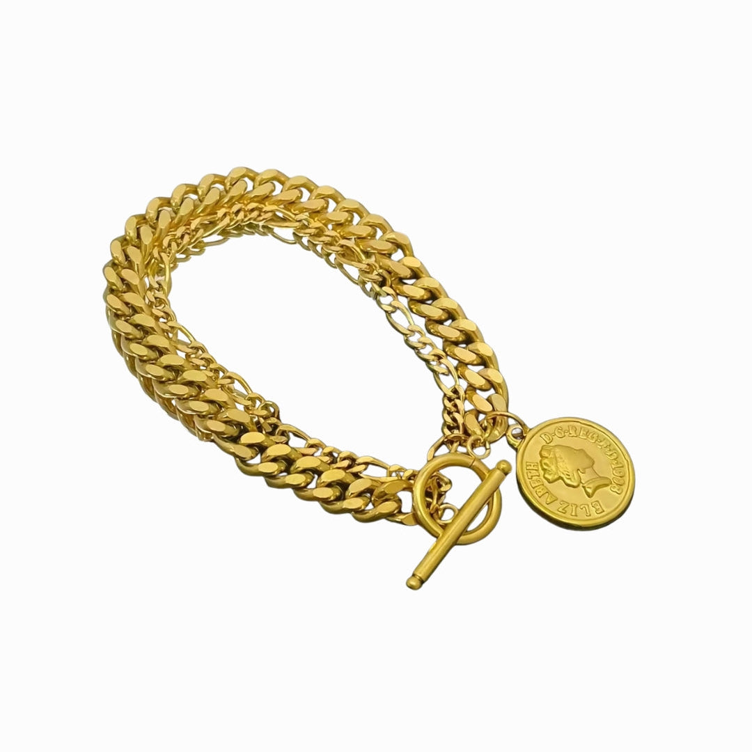 Gold chain bracelet with a round pendant on a white background