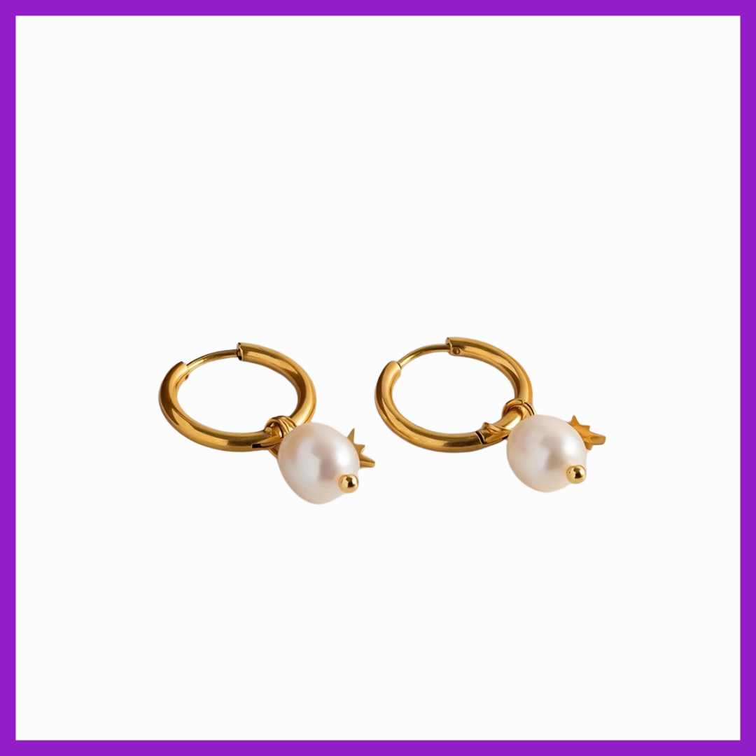 Gold hoop earrings with pearl drops on a white background