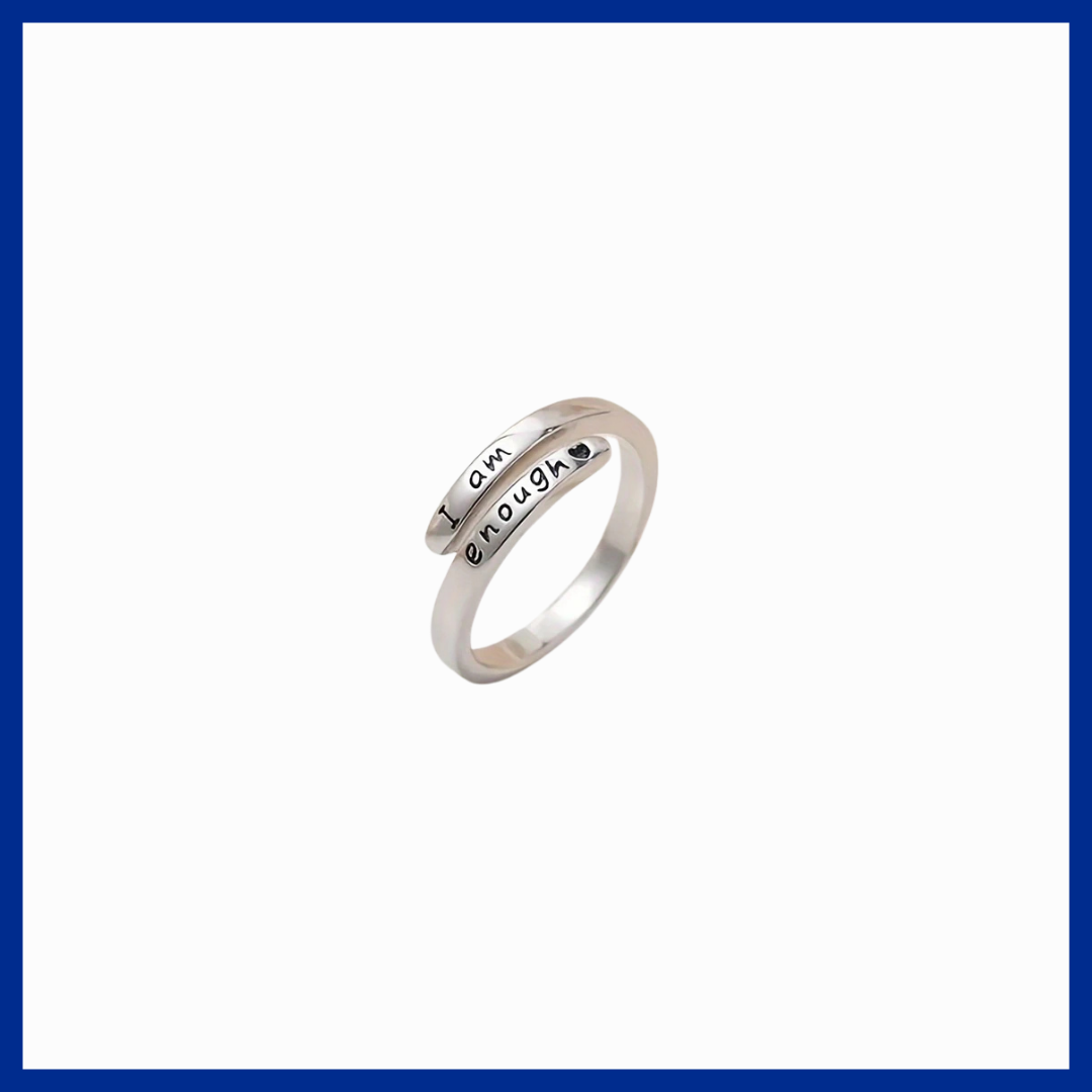 Silver ring with engraved text on a white background