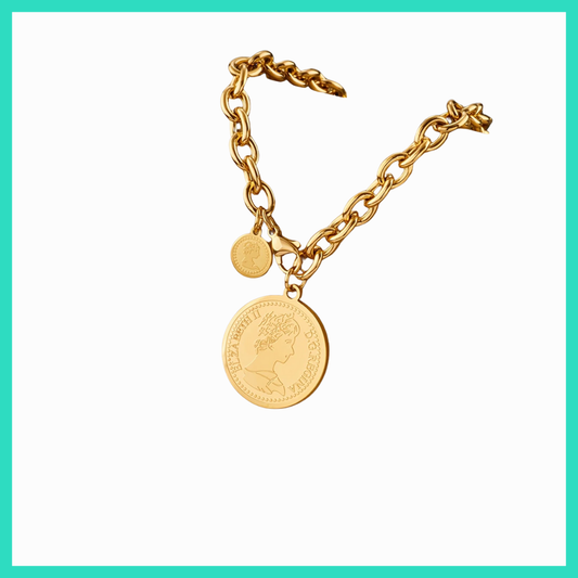 Gold chain bracelet with a coin charm on a white background
