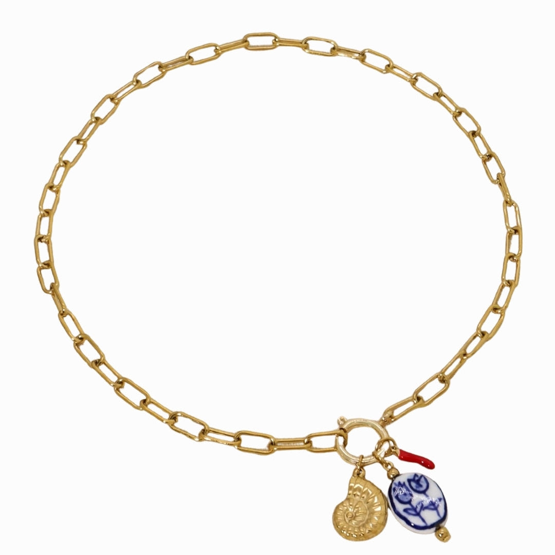 Gold chain bracelet with charms on a white background
