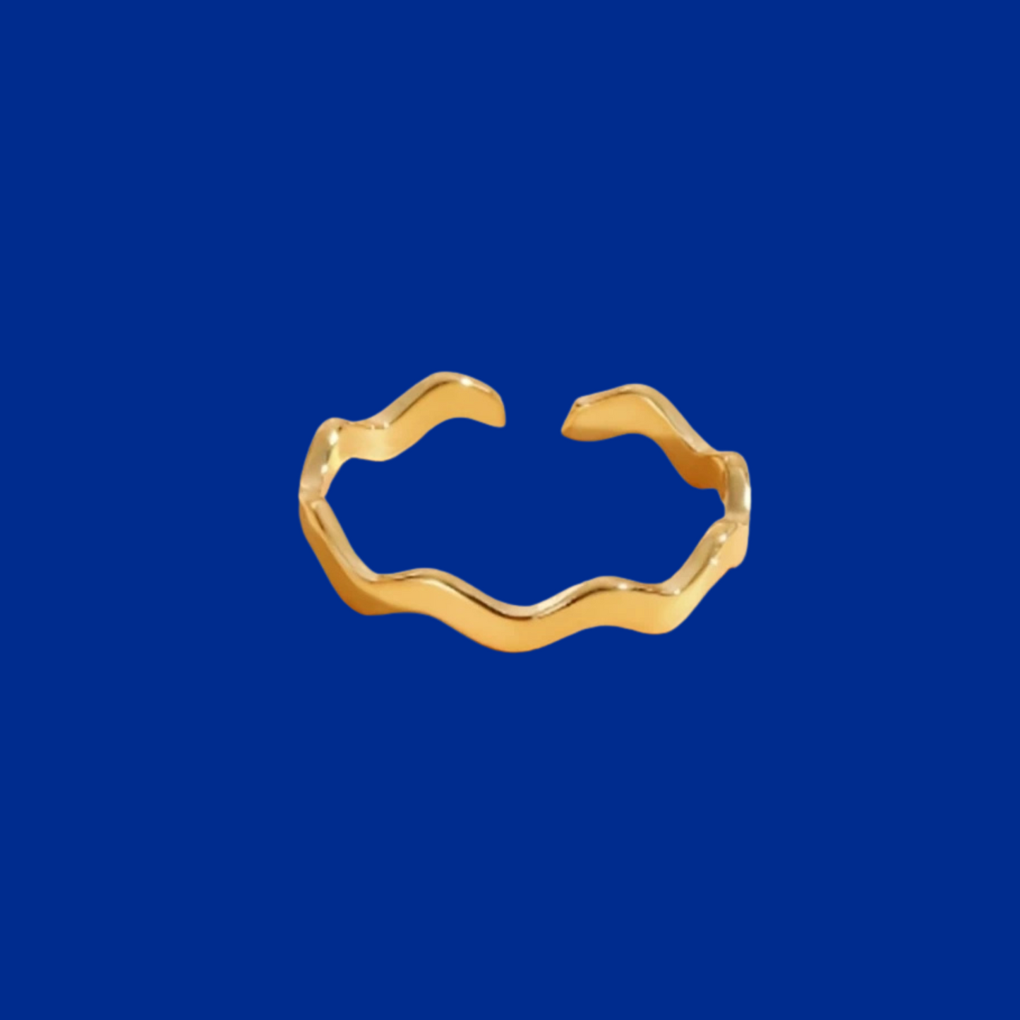 Gold ring with wavy design on a blue background
