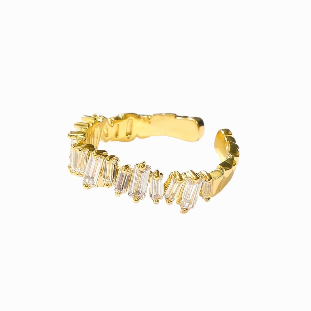 Gold ring with baguette cut gemstones on a white background