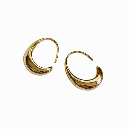 Gold hoop earrings on a white background