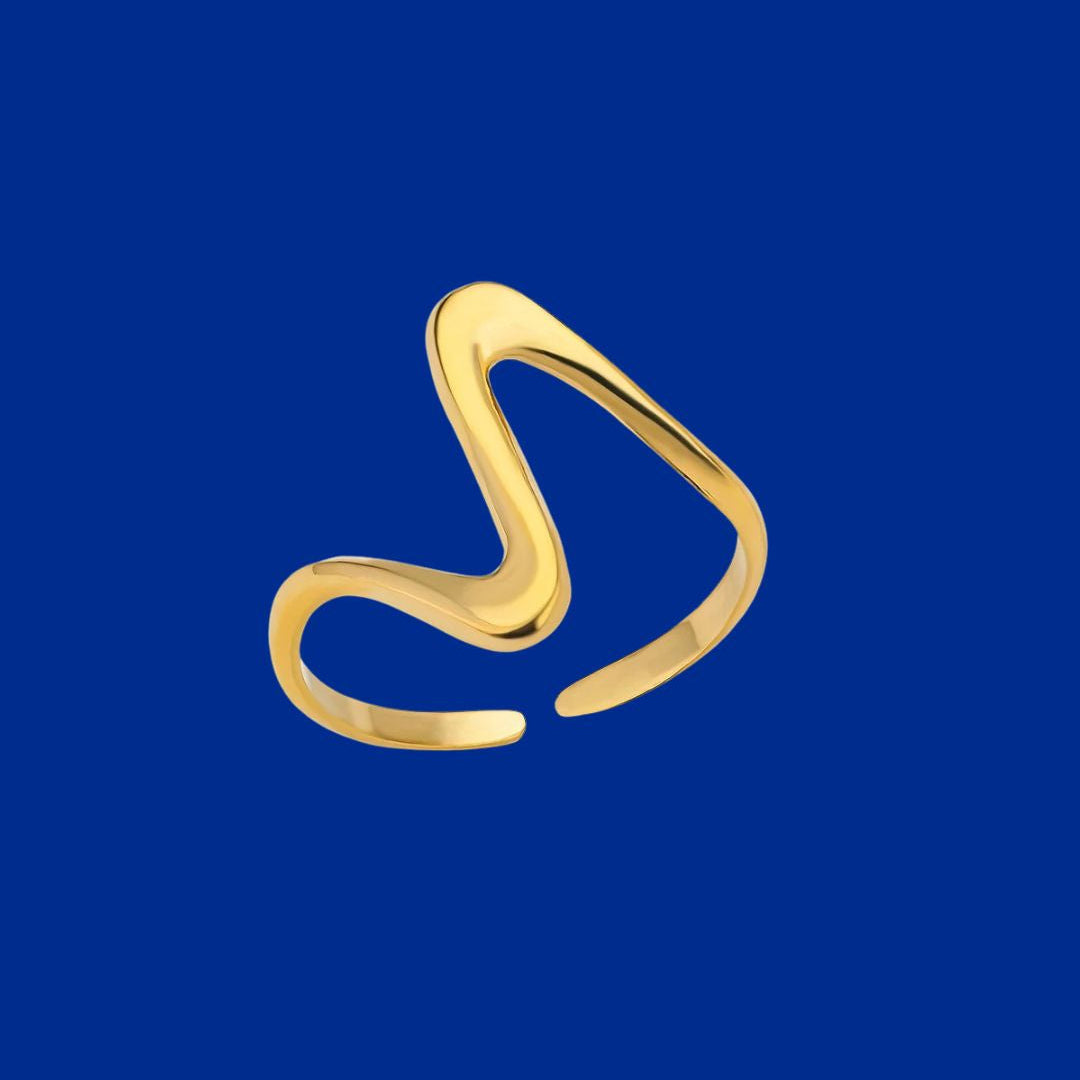Gold ring with a unique design on a blue background