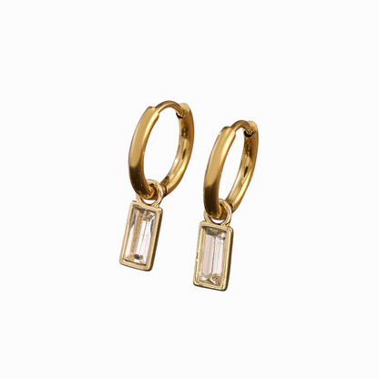 Gold hoop earrings with rectangular gemstones on a white background
