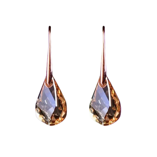 Teardrop-shaped earrings with a metallic finish on a white background