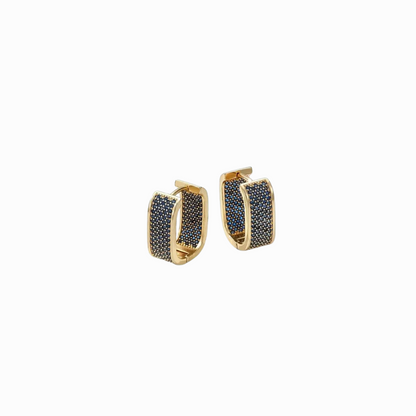 Gold hoop earrings with black stones on a white background