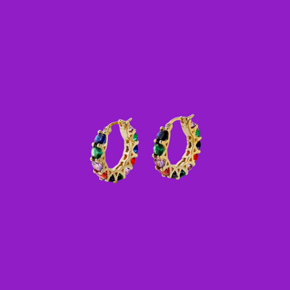 Colorful hoop earrings on a purple background