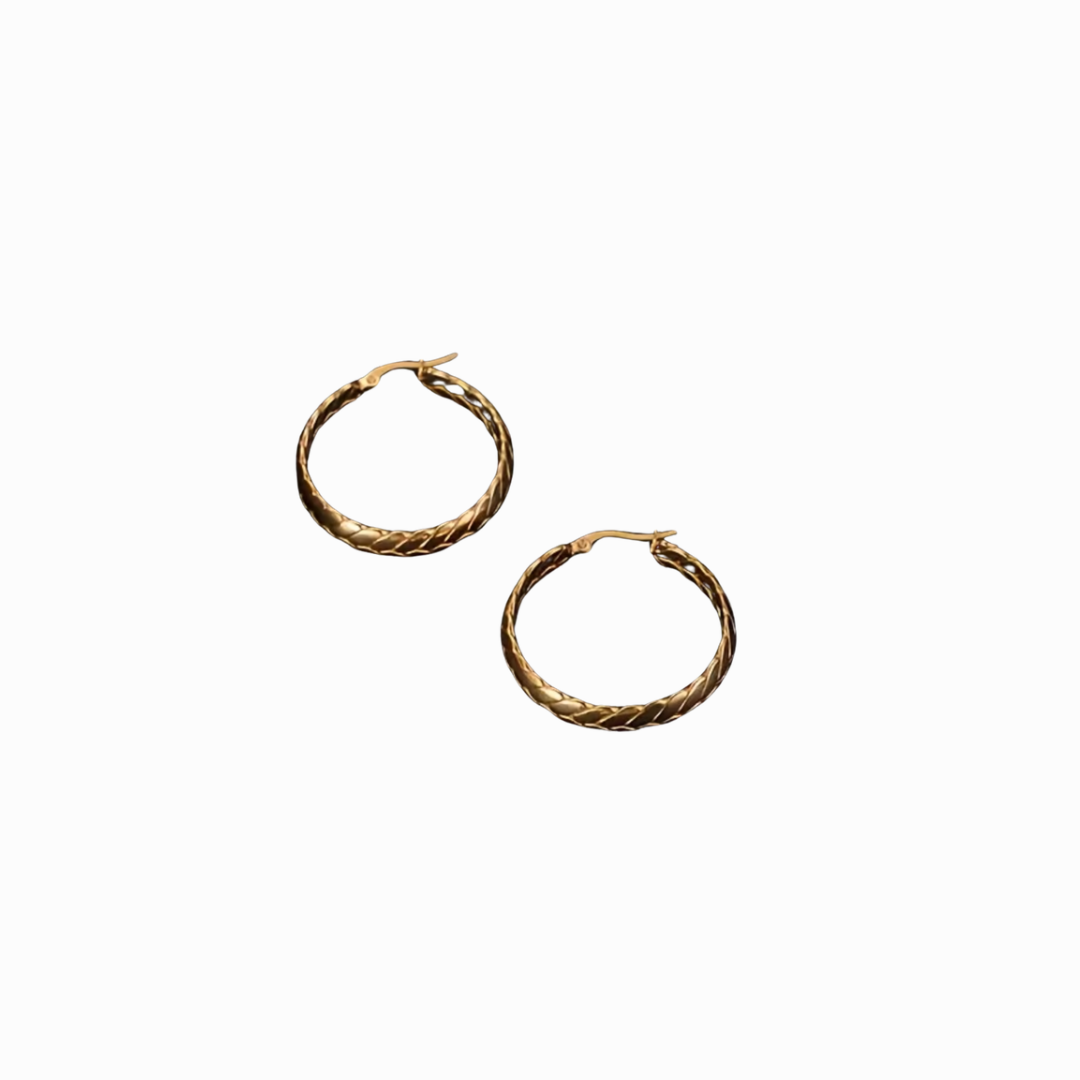 Gold hoop earrings on a white background