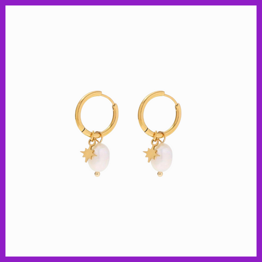 Gold hoop earrings with pearl and star charms on a white background