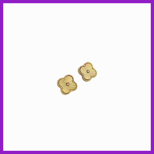 Gold floral earrings on a white background with a purple border