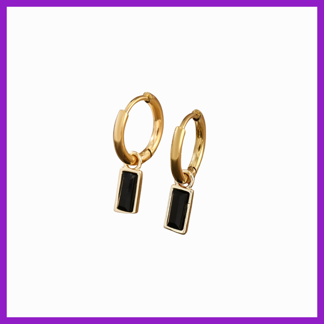 Gold hoop earrings with black rectangular stones on a white background