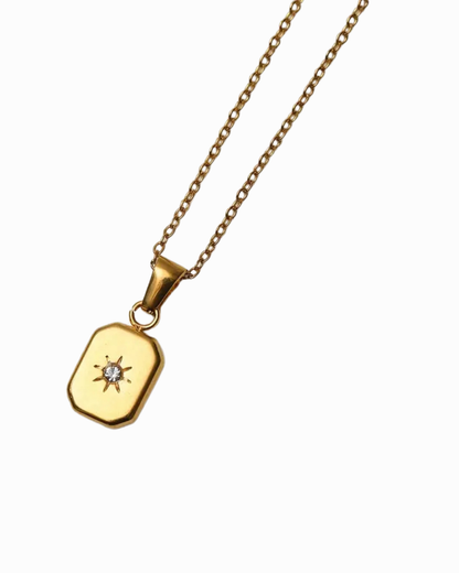 Gold necklace with a pendant on a white background