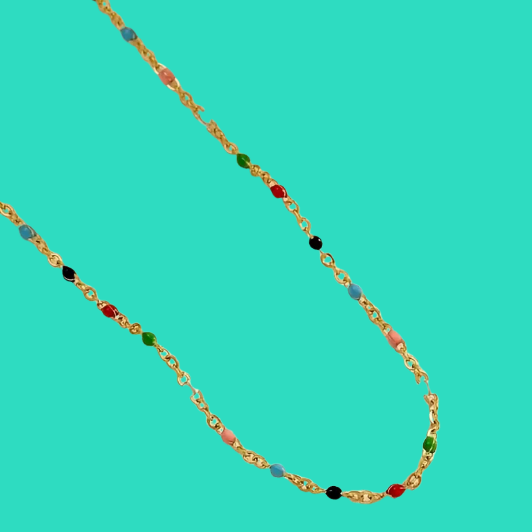 Gold chain necklace with colored beads on a turquoise background