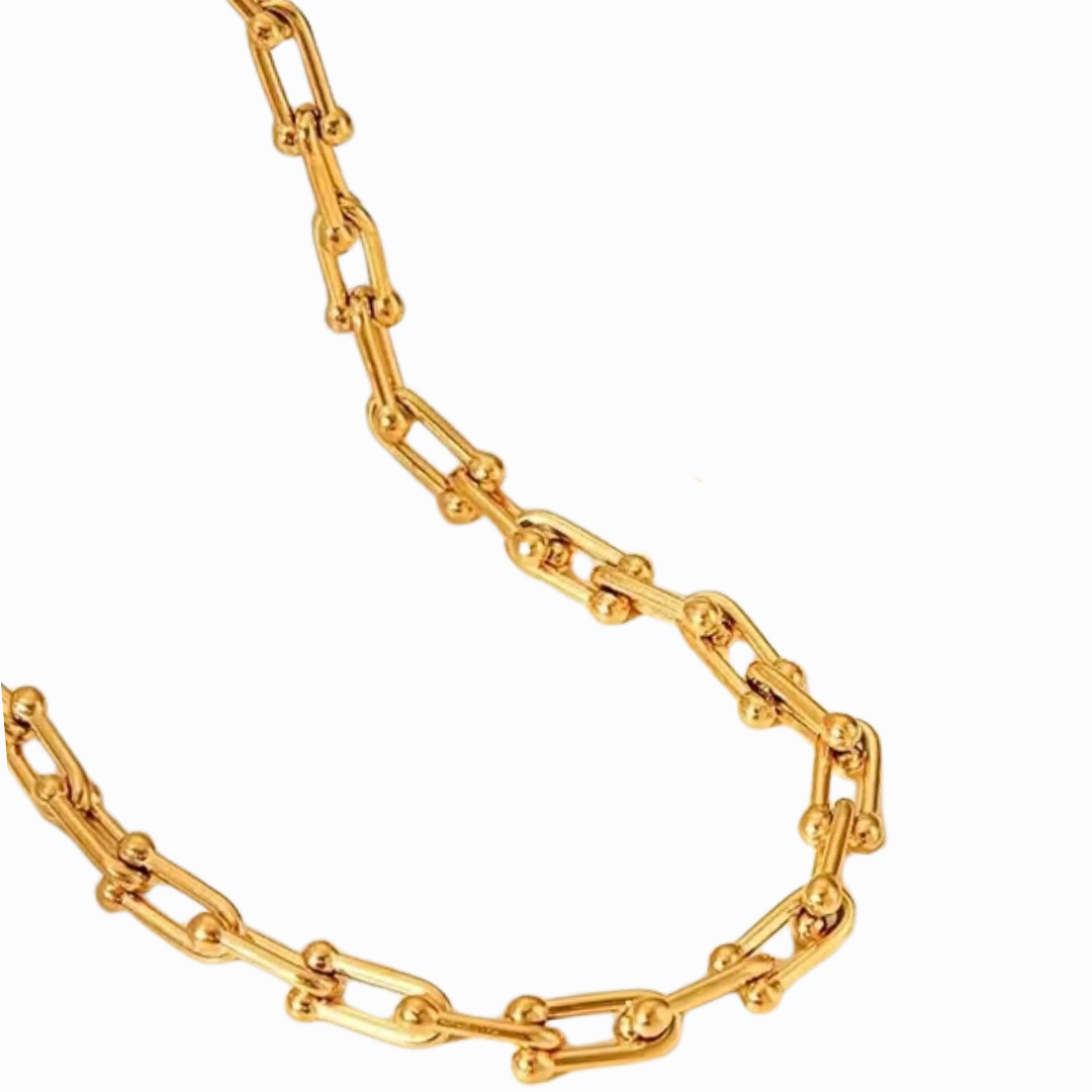 Gold chain necklace on white background