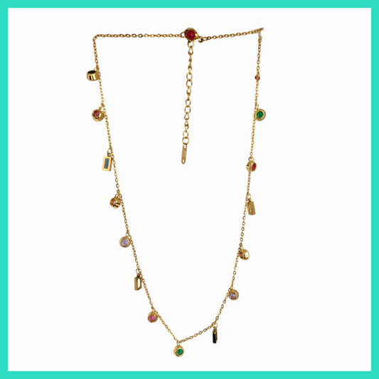 Gold necklace with colorful gemstones on a light green background