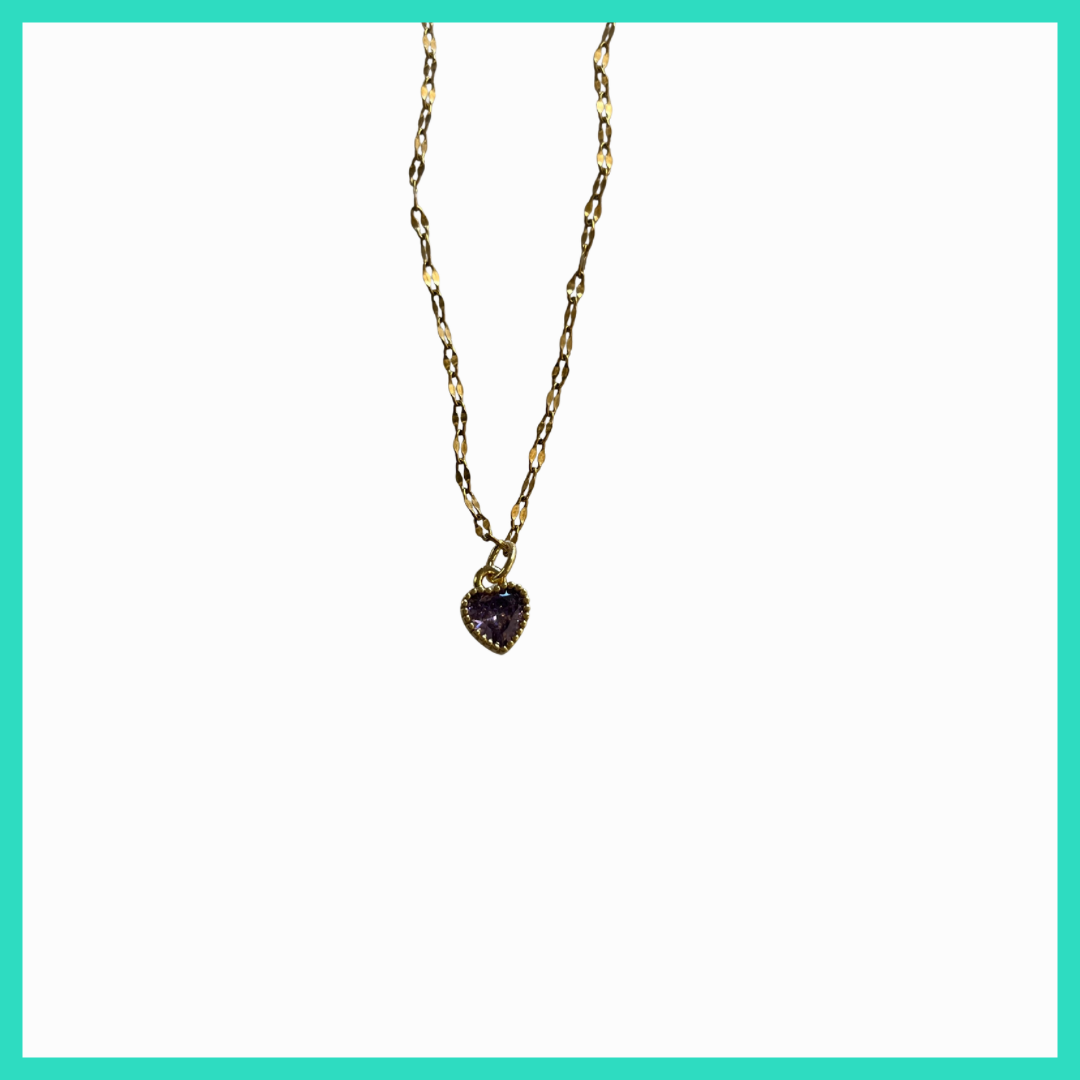Gold necklace with a heart-shaped purple gemstone pendant on a white background