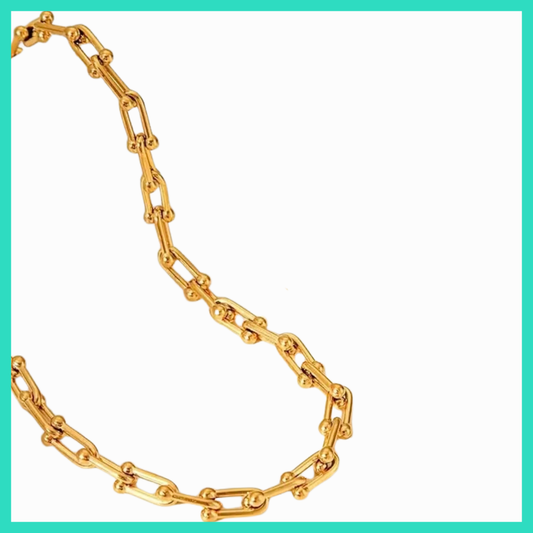 Gold chain necklace on a white background
