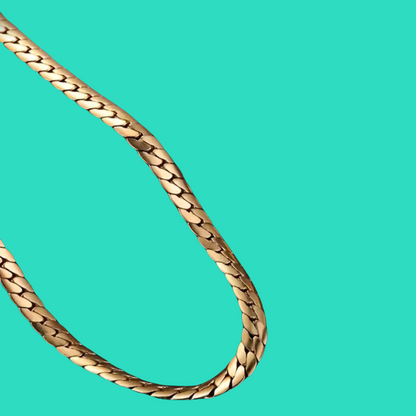 Gold chain on a turquoise background