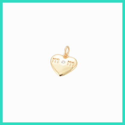 Gold heart-shaped pendant with engraved initials on a white background