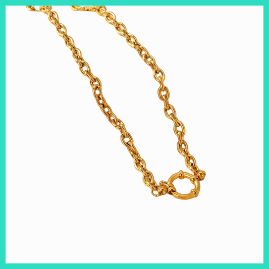 Gold chain necklace with a clasp on a white background