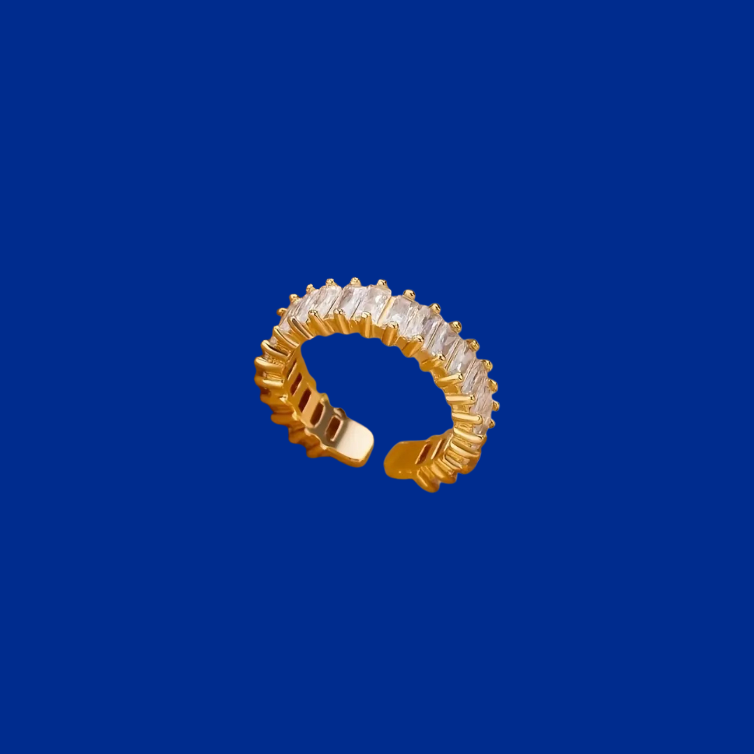 Gold ring with clear stones on a blue background