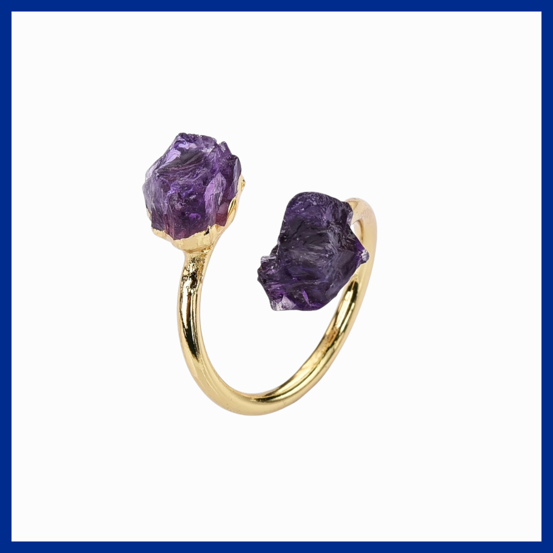 Gold hoop earrings with purple gemstones on a white background