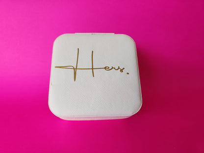 White jewelry box with 'Hers' engraving on a pink background
