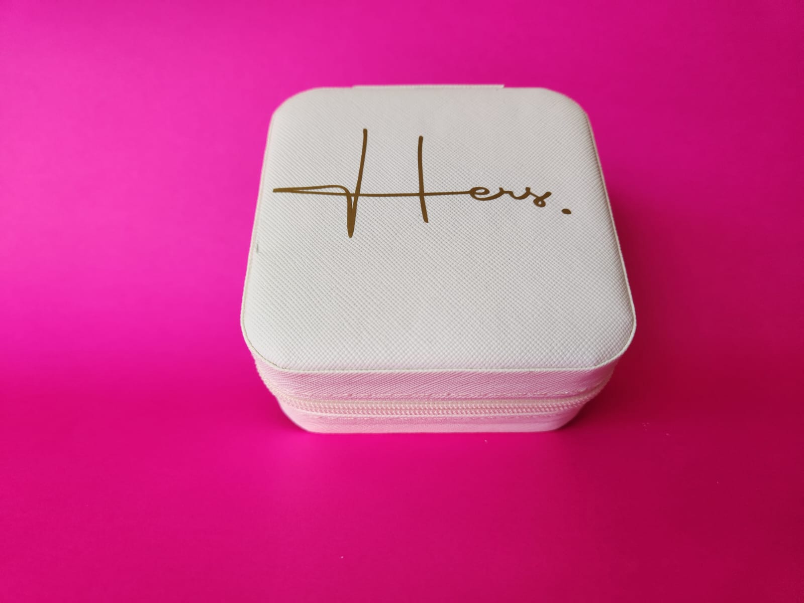 White jewelry box with 'Hers' engraving on a pink background