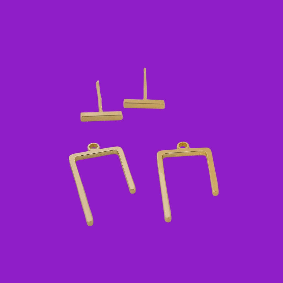 Four gold-colored earring on a purple background