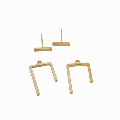 Gold earring components on a white background